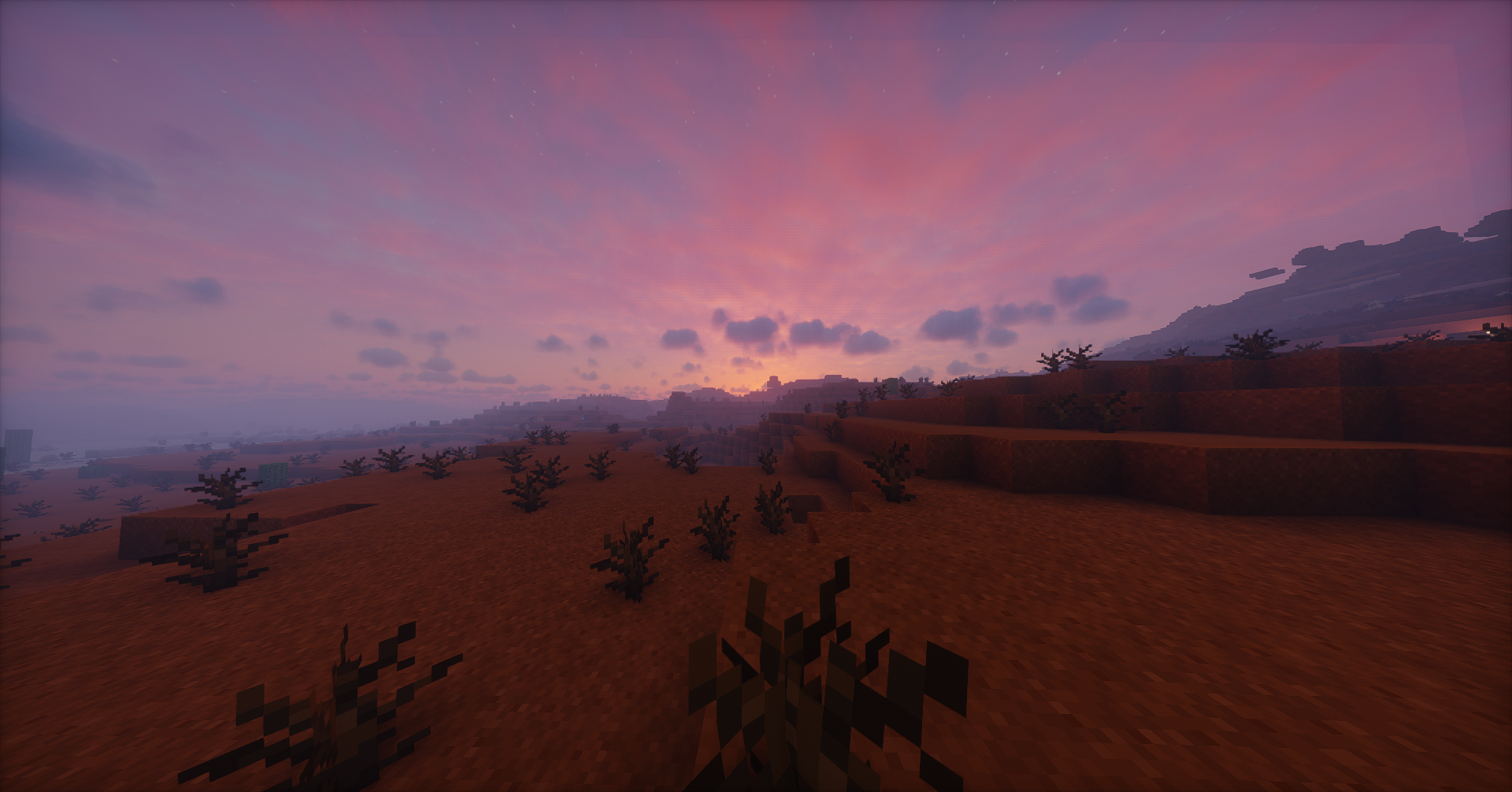 A picture of a Minecraft mesa landscape at sunset